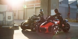 A couple in an urban area both riding Can-Am Spyders
